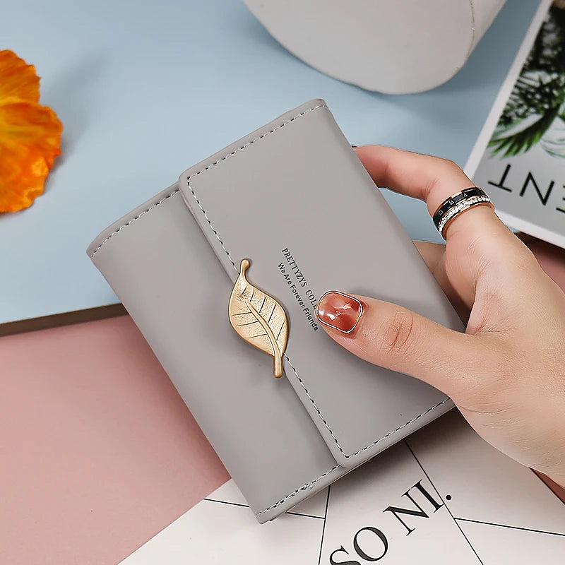 2024 Purse women's short high-end boutique fashion personality hardware leaf buckle short three fold bag multi-card folding stud