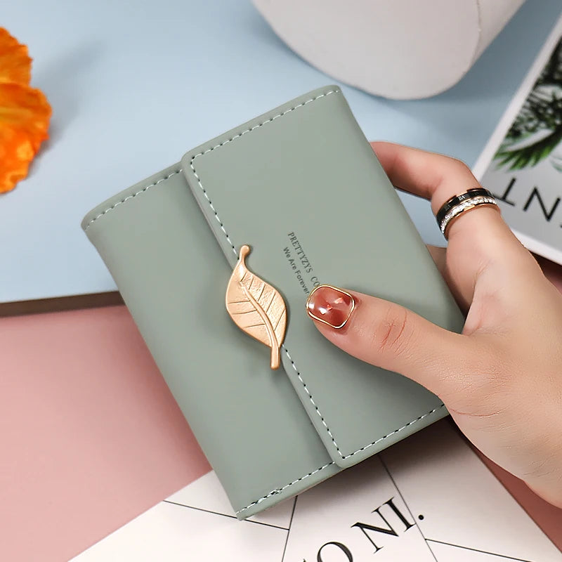 2024 Purse women's short high-end boutique fashion personality hardware leaf buckle short three fold bag multi-card folding stud